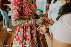 Red Bridal Lehenga with Intricate Mehndi and Bangles