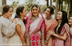 Bridal party in pink and cream attire with intricate jewelry