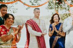 Groom in Sherwani with Wedding Guests During Outdoor Ceremony