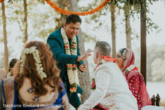 Outdoor Wedding Ceremony with Floral Garlands and Teal Suit