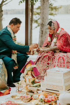 Outdoor Ceremony Ritual with Bride in Red Lehenga