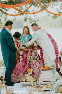 Outdoor Ceremony with Pink Bridal Lehenga and Floral Decor