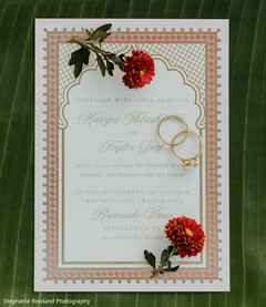 Elegant Wedding Invitation with Gold Rings and Floral Accents