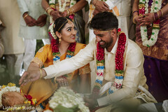 Couple with floral garlands during ceremony