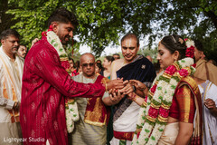 Couple exchanging garlands at outdoor ceremony