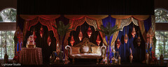 Elegant Stage Decor with Gold Sofa, Red Lanterns, and Drapes