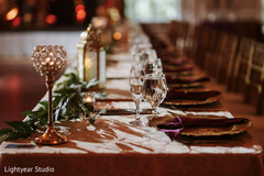 Elegant Wedding Table Setting with Gold Accents and Greenery
