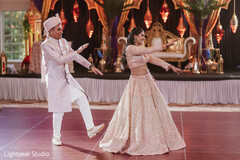 Couple dancing in elegant South Asian wedding fashion