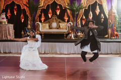 Wedding Guests Perform Dance on Stage with Ornate Decor
