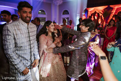 Guests dancing in traditional attire at a lively celebration
