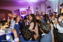 Joyful Wedding Reception Dance Floor with Guests and Couple