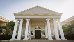 Couple Posing in Front of Grand White Columned Building