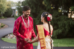 Couple in Traditional Attire with Floral Hair Adornment