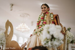 Bride on a palanquin with floral garlands