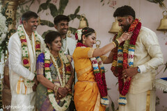 Couple exchanging floral garlands