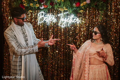 Couple Poses with Neon Sign and Gold Sequin Backdrop