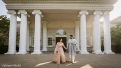 Couple walking before a grand white building