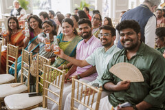 Guests Toasting at a Wedding Celebration with Orange Drinks