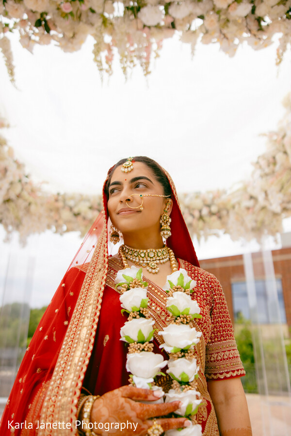 bridal portrait,red bridal lehenga,wedding garland,floral mandap,bridal jewelry,bridal fashion,traditional bride,hindu wedding,editorial portrait,south asian wedding