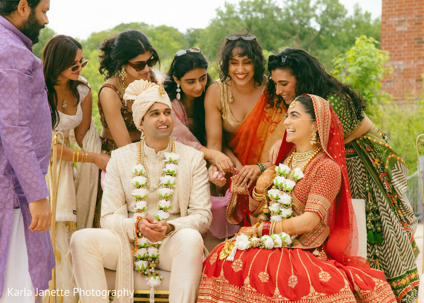 family moments,bride and groom,wedding guests,candid laughter,wedding celebration,newlyweds,traditional attire,wedding joy,group portrait,south asian wedding