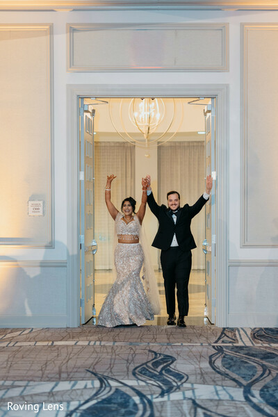 grand entrance,wedding reception,bride and groom,reception entrance,celebration,newlyweds,candid joy,ballroom reception,wedding party,south asian wedding
