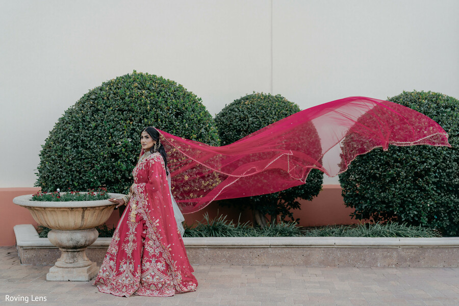 bridal portrait,red bridal lehenga,flowing dupatta,bridal fashion,outdoor portraits,embroidered lehenga,editorial portrait,elegant bride,wedding attire,south asian wedding