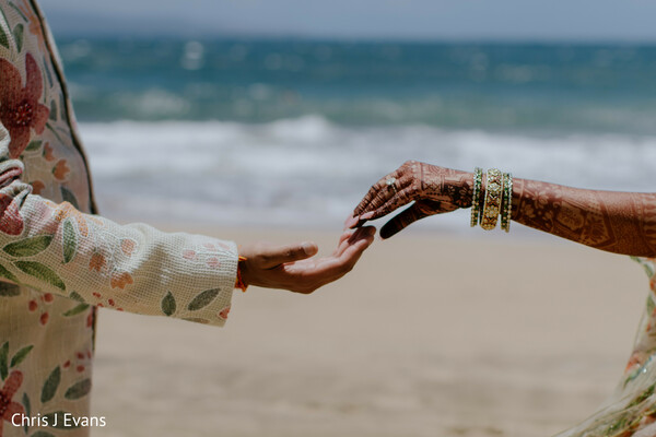 holding hands,beach portraits,destination wedding,romantic details,ocean backdrop,intimate moments,floral outfits,symbolic love,close up,south asian wedding