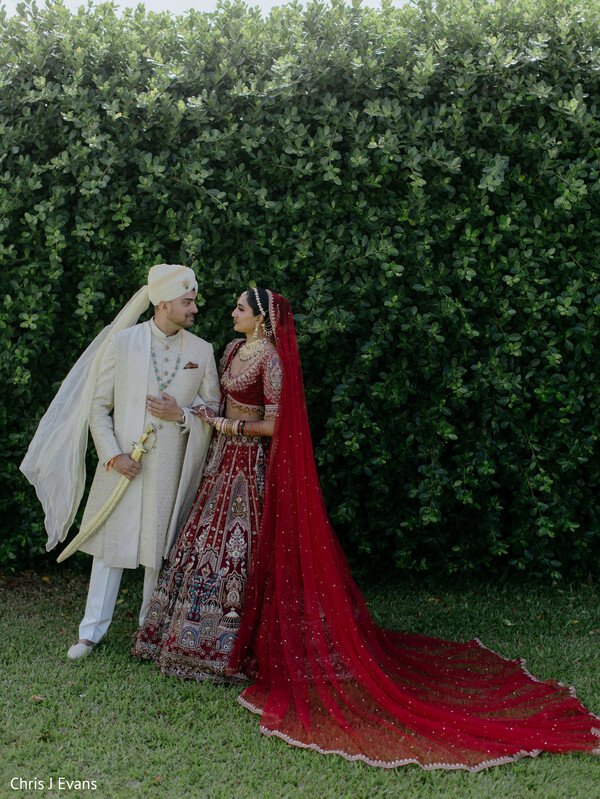 bride and groom,bridal portraits,red bridal lehenga,ivory sherwani,flowing dupatta,romantic couple,outdoor portraits,wedding fashion,elegant romance,south asian wedding