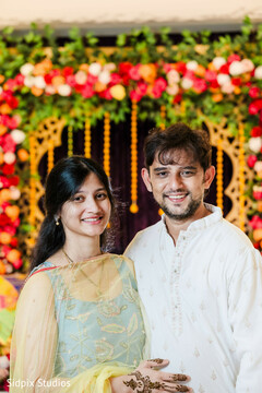 Couple Poses in Front of a Colorful Floral Backdrop