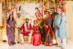 Vibrant Family Portrait with Radha Krishna Backdrop