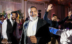 Man with White Beard Dances at a Lively Reception