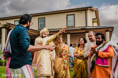 Man Hands Garland to Groom
