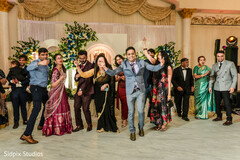 Wedding Guests Energetically Dance at a Reception