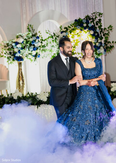 Elegant Couple's Grand Entrance with Blue Hues and Dramatic Fog