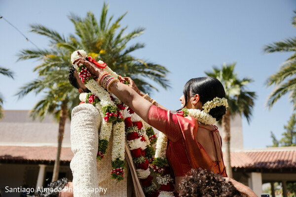 floral garlands,wedding ceremony,bride,groom,outdoor wedding,palm trees,floral decor