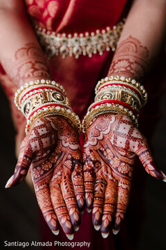 Hands Adorned with Intricate Mehndi and Stacked Bangles