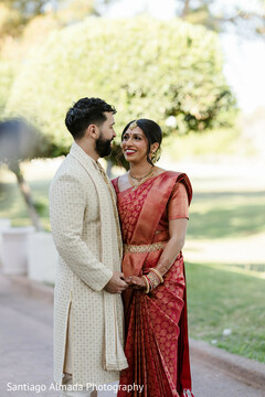 Couple in Red Sari and Cream Sherwani