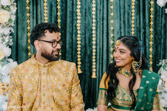 Couple Shares a Joyful Look Amidst Green and Gold Decor