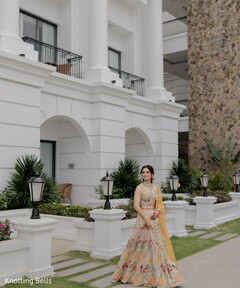 Bride in Peach Floral Lehenga with Yellow Dupatta