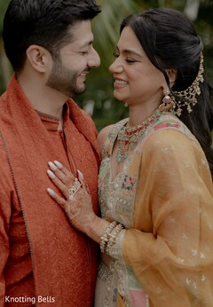 Couple in Orange-Red Kurta and Embellished Outfit