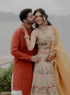 Groom Kisses Bride's Cheek in Outdoor Portrait by the Water