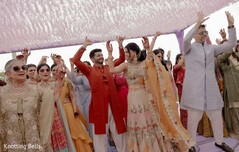 Joyful Couple Dances Under Canopy at Vibrant South Asian Celebration