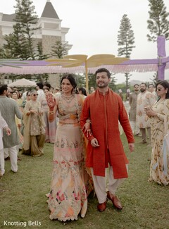 Couple Walking: Bride in Beige Lehenga, Groom in Rust Kurta
