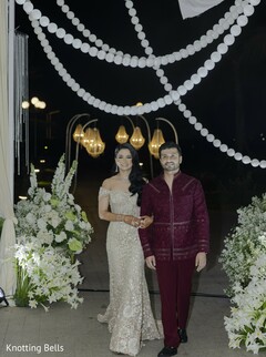 Glamorous Entrance: Bride in Off-Shoulder Gown and Groom in Maroon Sherwani