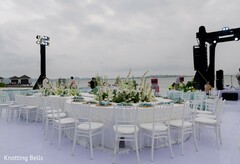 Elegant Outdoor Reception with White Floral Centerpieces and Waterfront Views