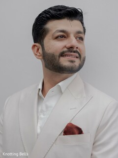 Groom's Elegant Portrait in a Crisp Cream Suit with Burgundy Pocket Square