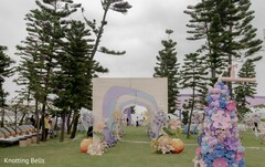 Outdoor Wedding Aisle with Pastel Arch and Floral Decor