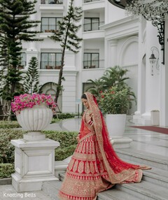 Bride in Red Lehenga with Embroidery on Outdoor Stairs