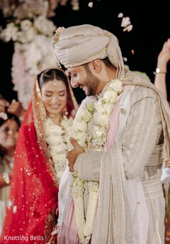 Couple Smiles During Rose Petal Shower