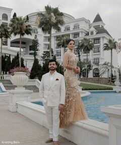 Couple Poses by Pool in Champagne Embellished Gown and Ivory Suit